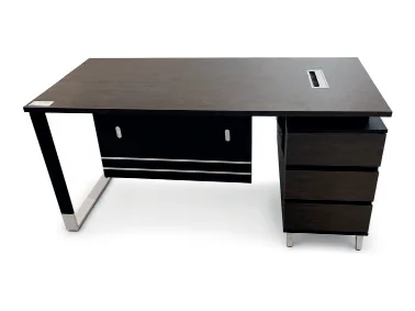 Dark executive table on a chrome sled leg with a drawer pedestal